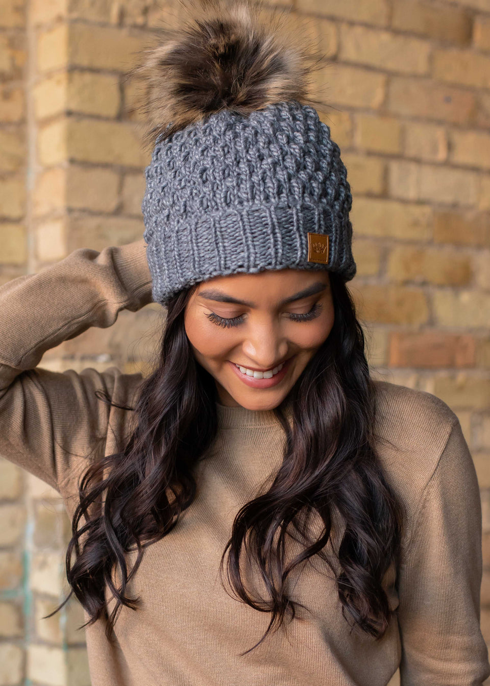 Grey textured cuffed fleece lined knit hat with pom detail